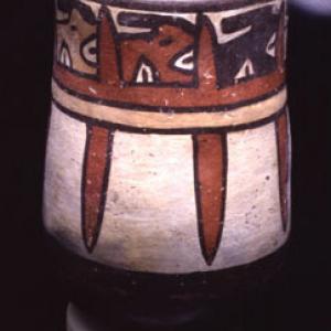 Glass with stylized representation of "trophy heads", 125 B.C. - 200 A.D. (Nasca 4)