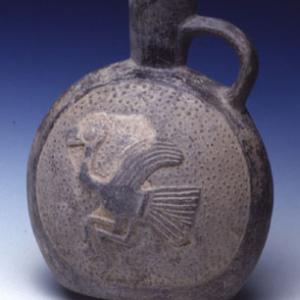 Discidal flask decorated in relief by a stylized bird on a "goose flesh" bottom