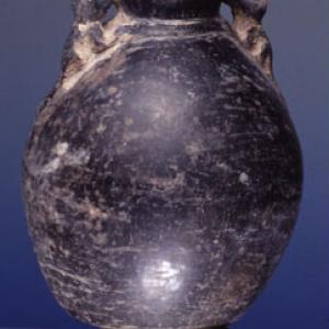 Vase-bottle with two zoomorphic plastic figures on the sides of the neck