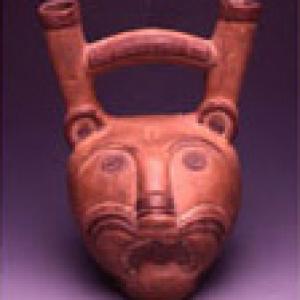 Vase with a bridge shaped handle representing the head of a jaguar